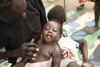 Bathi Kuju is playing with his youngest daughter Gol at a nutrition centre in Pibor, South Sudan