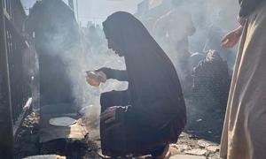 Displaced Palestinians gather near a shelter run by the UN agency for Palestinian refugees (UNRWA) in the Nuseirat area of ​​central Gaza.