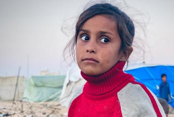A displaced girl waits her turn to fetch water for her family in the southern city of Rafah in Gaza.