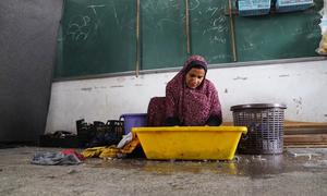 A displaced Palestinian woman washes clothes in a classroom at shelter run by the UN agency for Palestine refugees, UNRWA, in Khan Younis, southern Gaza.