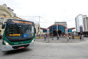 Um ônibus verde e branco, da linha 525, está em frente ao Terminal Parobé, no Centro Histórico de Porto Alegre, Brasil.