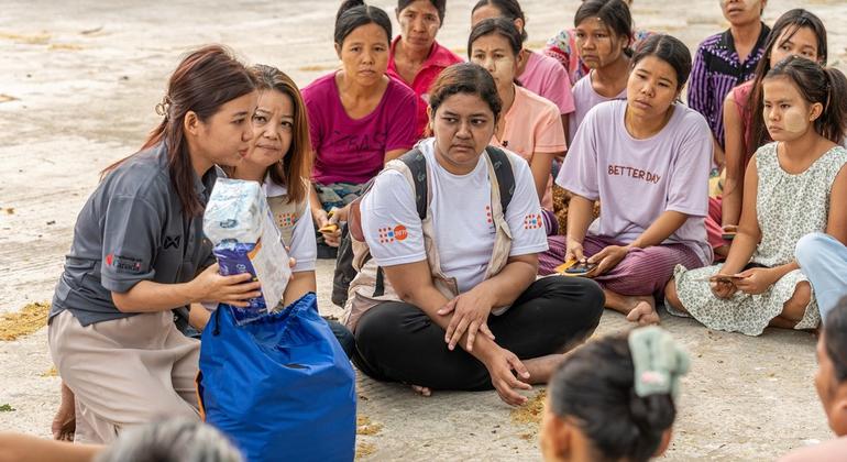 At the emergency relief item distribution, UNFPA staff introduces the content of the dignity kits and provides information on gender-based violence for earthquake- affected women and girls in Mandalay, Myanmar.