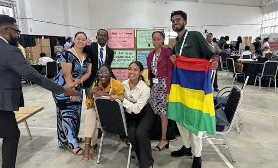 Delegates to the SIDS Global Children and Youth Action Summit including Adelaide Nafoi of Samoa (second from left) after completing their section of the “wall of commitment”.