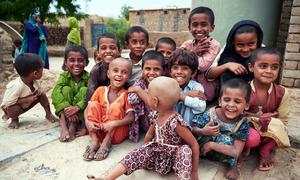 A group of children smile in Ismail Bhand village in Pakistan's Shaheed Benazirabad district, Sindh province.