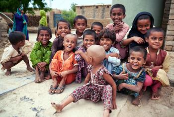 A group of children smile in Ismail Bhand village in Pakistan's Shaheed Benazirabad district, Sindh province.