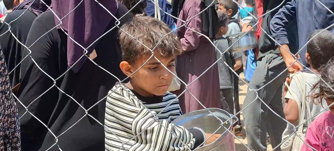 A Palestinian child in Gaza after receiving a meal during food distribution in central Gaza. A Palestinian child in Gaza after receiving a meal during food distribution in central Gaza.