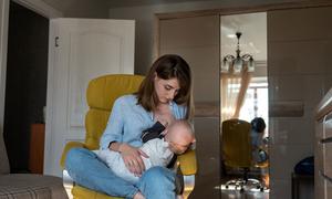 A mother breastfeeds her six-month old child in Ukraine.