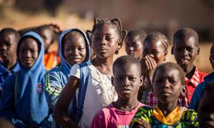 Children wait to enter their classroom at a school in Burkina Faso.