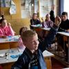 أطفال يحضرون فصلًا في مدرسة في أوليساريفكا، أوكرانيا. كانت القرية على خط المواجهة لأسابيع خلال النزاع وتعرضت لأضرار جسيمة.