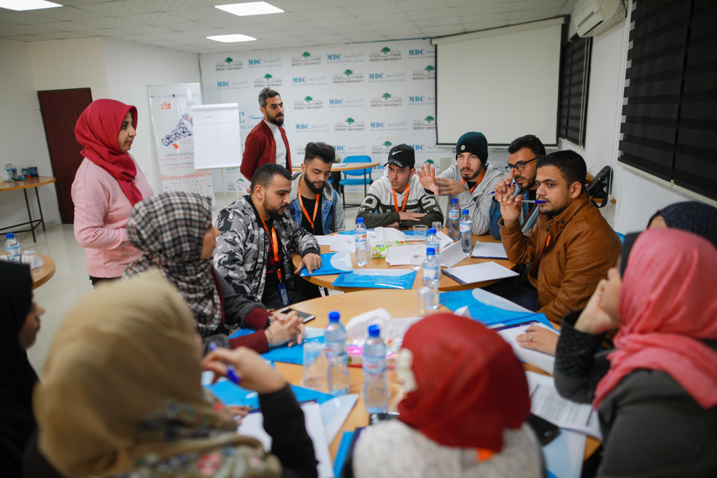 Young journalists attend training at the Media Development Center in Gaza, before the COVID-19 pandemic.