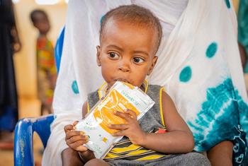A displaced child eats nutrition paste at a clinic in Bawa, Mali.