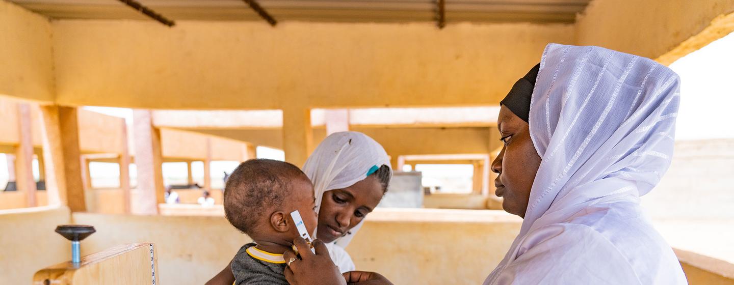 Un enfant est soigné pour malnutrition dans une clinique mobile sur un site de personnes déplacées au Mali.