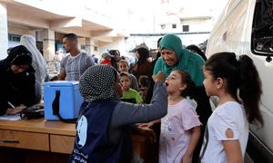 Ferial, a grandmother took her two granddaughters to Deir El Balah health center to get polio vaccination.