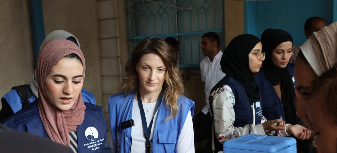 Louise Wateridge, UNRWA Spokesperson (middle) following the administering of polio vaccination in UNRWA's Deir El Balah health center. 