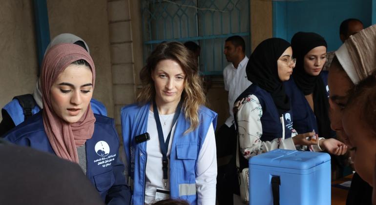 UNRWA spokesperson Louise Watridge (centre) is in charge of polio vaccination at the UNRWA health center in Deir al-Balah. 