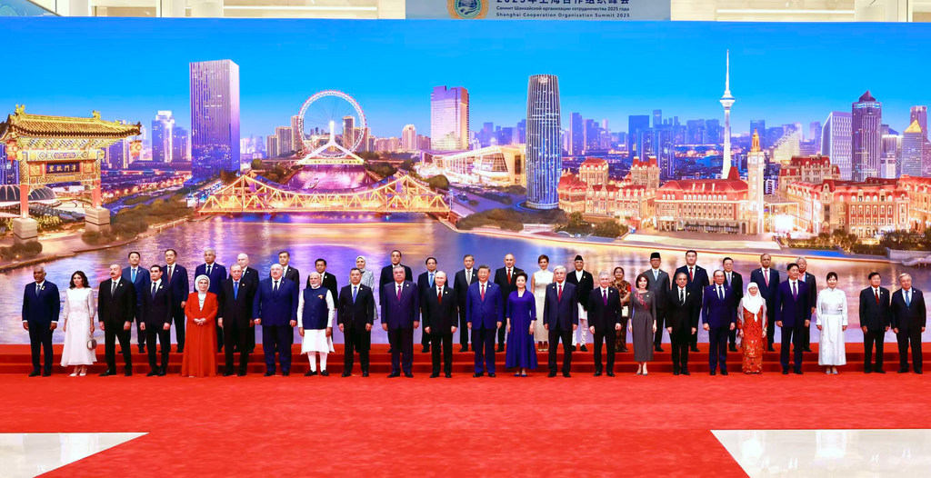 Picha ya pamoja ya viongozi katika Mkutano wa Wakuu wa Shirika la Ushirikiano la Shanghai 2025 huko Shanghai, ikiwa na mandhari ya jiji.