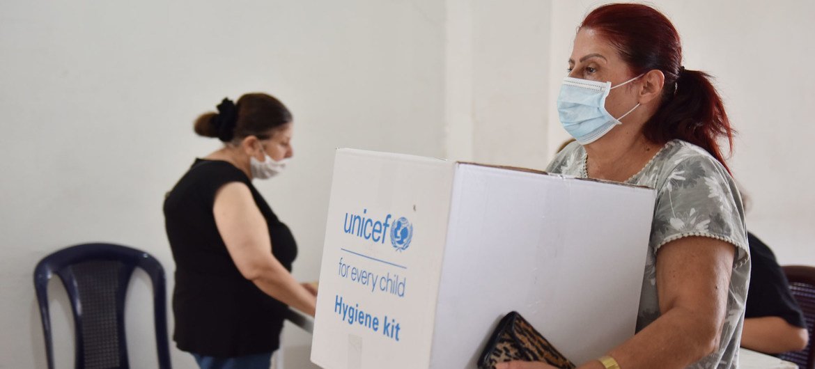 A woman collects a hygiene kit in Bourj Hummoud, Lebanon. (file)