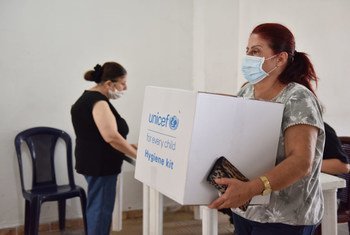 A woman collects a hygiene kit in Bourj Hummoud, Lebanon. (file)