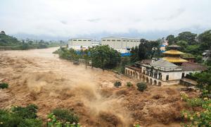 A swollen river surges through Kathmandu, Nepal's capital, after the heaviest rainfall in over 50 years.