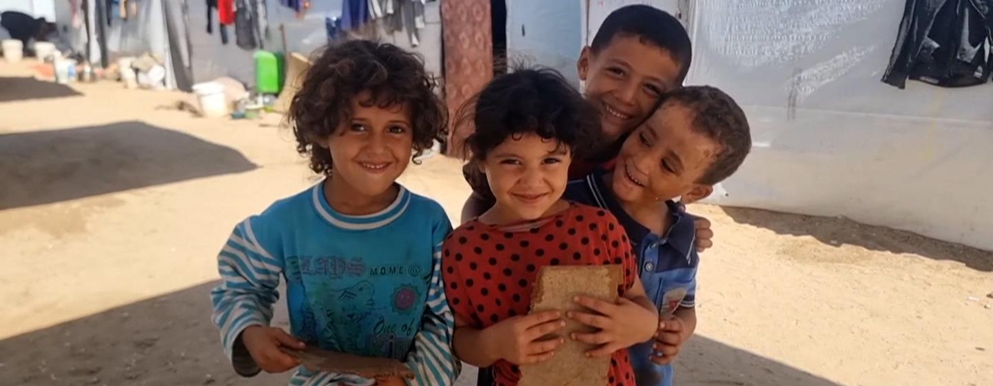 Orphaned children gathered in an open space in the Al-Baraka camp in the Al-Mawasi area of Khan Younis.