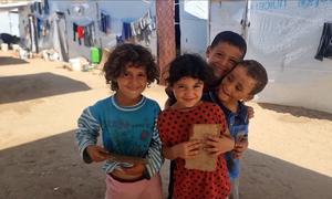 Orphaned children gathered in an open space in the Al-Baraka camp in the Al-Mawasi area of Khan Younis.