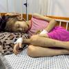 Jana, 9 ans, sur son lit d'hôpital à Gaza-ville, le 25 août 2025, aux côtés de sa mère, Nesma.