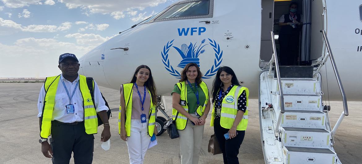 UNHAS crew members pose outside an aircraft at Qamishli airport in northeastern Syria.