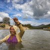 Uma mulher local usa uma rede para pescar nas águas rasas do rio Rupununi, na Guiana
