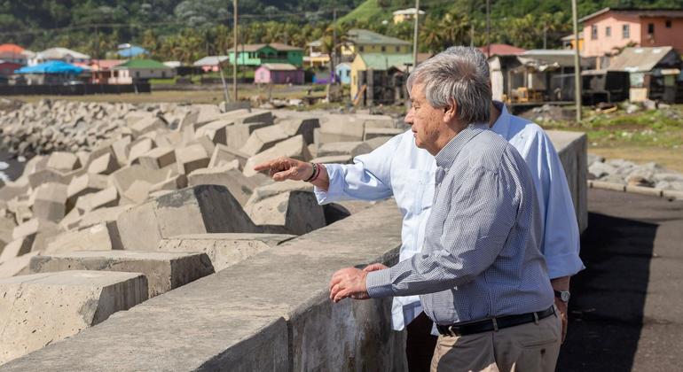 UN Secretary-General António Guterres (foreground) and Ralph E. Gonsalves, Prime Minister of Saint Vincent and the Grenadines survey the sea defense project underway in Sandy Bay as part of the island nation's efforts to protect against sea-level rise.