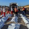 Rescue workers line up body bags in Tal Al Sultan, in Rafah, in southern Gaza. 
