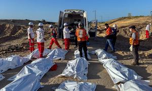Rescue workers line up body bags in Tal Al Sultan, in Rafah, in southern Gaza. 