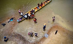 Migrants come ashore after crossing the Darién Gap in Panama.