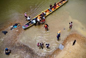 Migrants come ashore after crossing the Darién Gap in Panama.