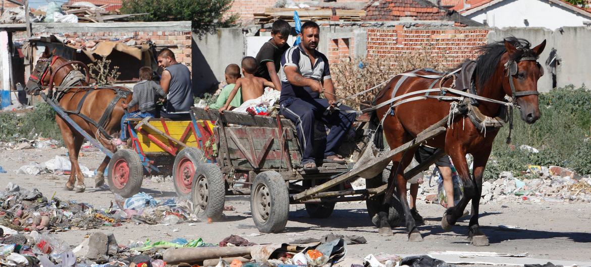 Members of the Roma community in Europe continue to face hardships and discrimination, with many living in poverty. In this file photo, a Roma men and children work at a junkyard in Bulgaria.