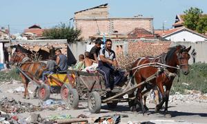 Members of the Roma community in Europe continue to face hardships and discrimination, with many living in poverty. In this file photo, a Roma men and children work at a junkyard in Bulgaria.