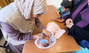 An infant receives a polio vaccination shot in an UNRWA clinic in Al-Nuseirat camp, central Gaza Strip.