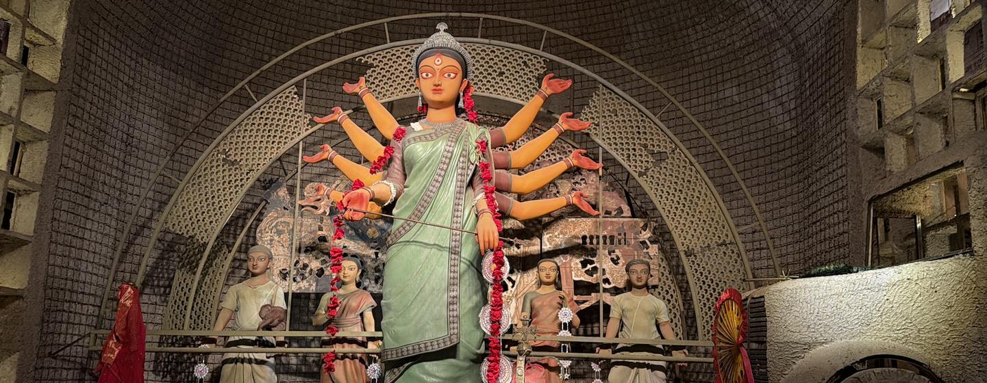 A Durga Puja pandal on the theme of riots, urges peace and harmonious community life.