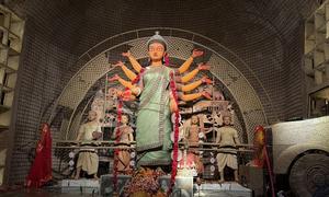 A Durga Puja pandal on the theme of riots, urges peace and harmonious community life.