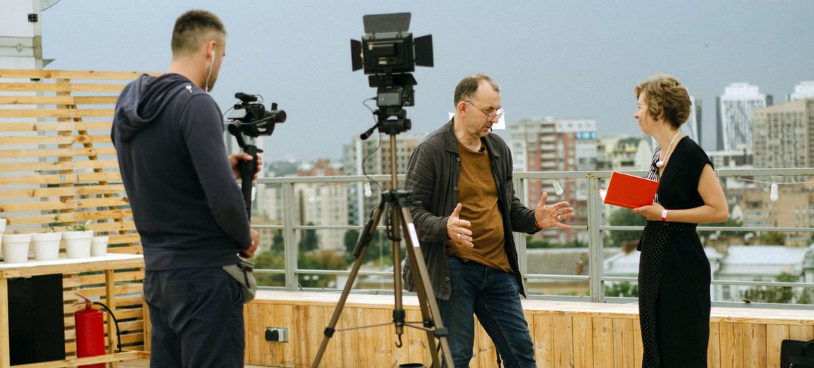 Journalists work on a rooftop in Kyiv, Ukraine.