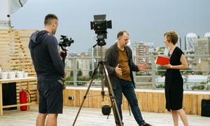 Journalists work on a rooftop in Kyiv, Ukraine.