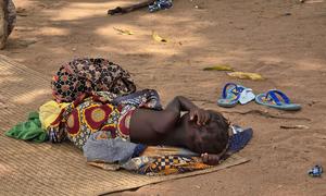 A child whose family fled violence in northern Mozambique rests at a site for displaced people.