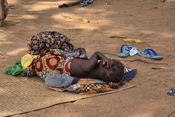 A child whose family fled violence in northern Mozambique rests at a site for displaced people.