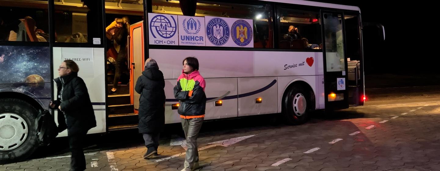 A bus operated by the United Nations takes Ukrainian refugees from Moldova to Romania.