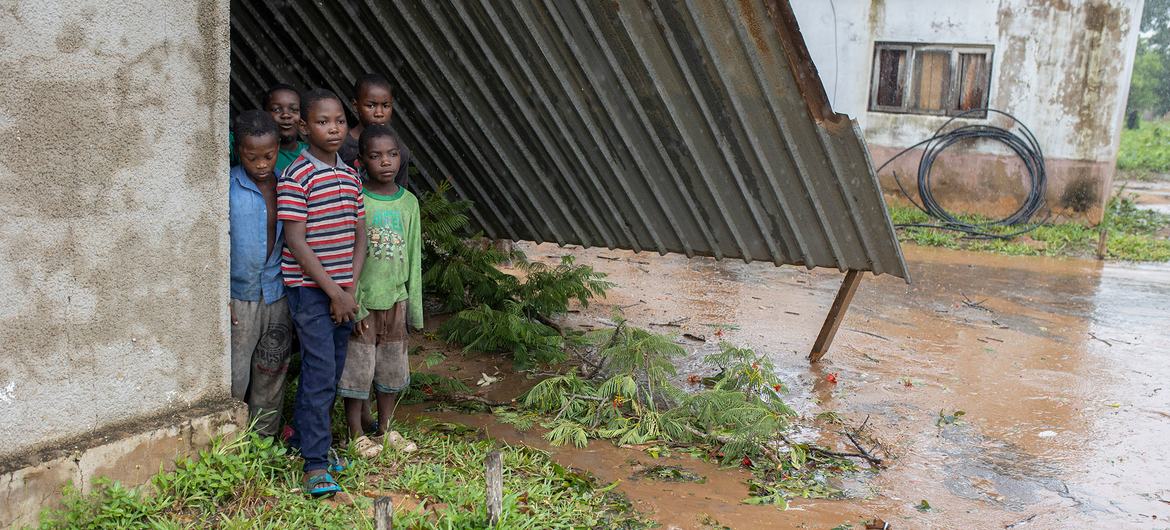 Children stand in the ruins of their school, destroyed by Cyclone Freddy in Mozambique.