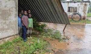 Children stand in the ruins of their school, destroyed by Cyclone Freddy in Mozambique.