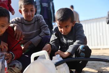 Children fill containers with drinking water in the Al-Shaboura neighbourhood in Rafah in southern Gaza.