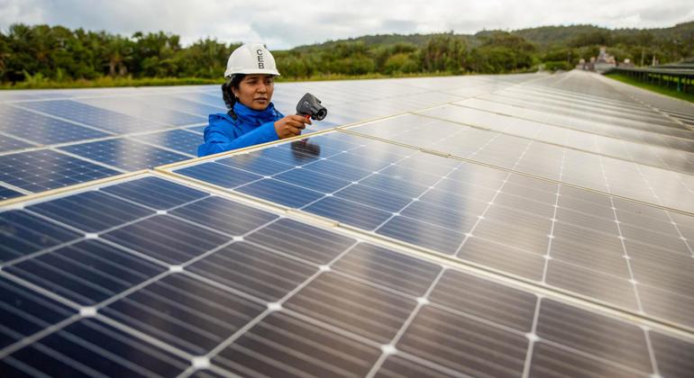 A woman works on a solar farm in Mauritius.