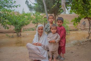 A grandmother sits with her three grandsons who were injured when flash floods hit their village in Baghlan province, Afghanistan.