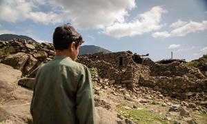 In Ghazi Abad village in the Kunar province, a boy stands in front of his home destroyed by the earthquake that hit eastern Afghanistan on 31 August.