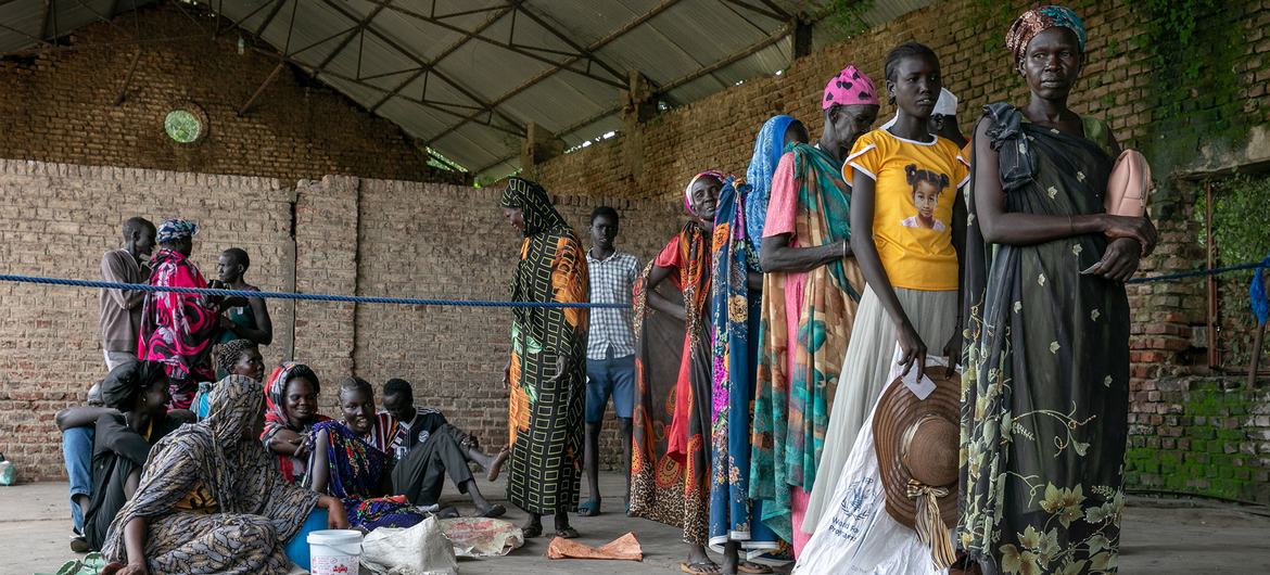 People wait in line at a food distribution site in Malakal, South Sudan.